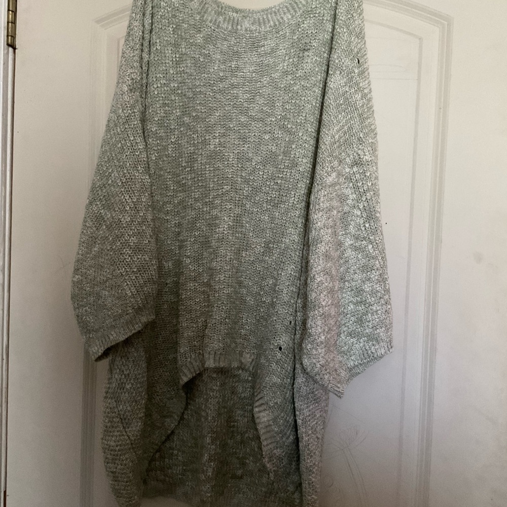 It’s a sweater that has short sleeves but wide sleeves